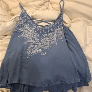 blue tank top with white flower embroidery
